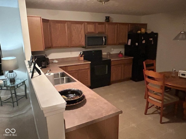 kitchen featuring black fridge, sink, and electric range