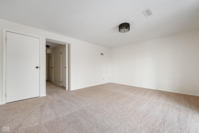 unfurnished room featuring light colored carpet