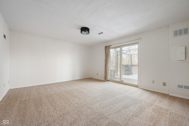 carpeted spare room with a textured ceiling