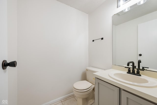 bathroom featuring vanity, tile patterned floors, and toilet