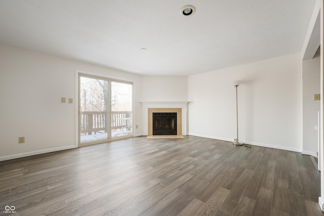 unfurnished living room featuring dark hardwood / wood-style flooring