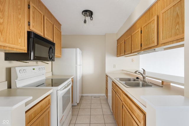 kitchen with sink, light tile patterned floors, and electric range