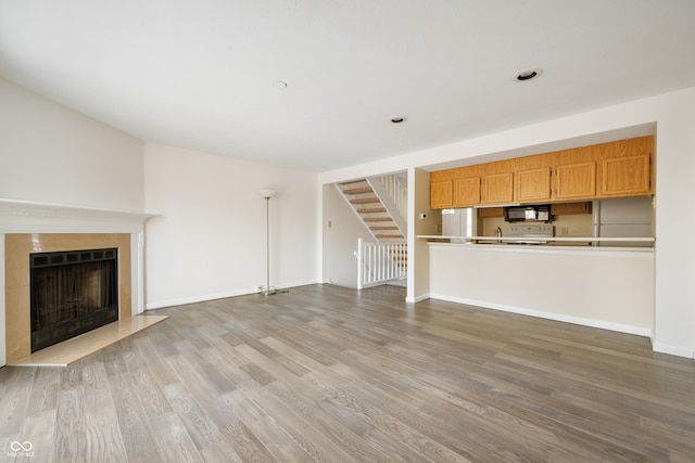 unfurnished living room with hardwood / wood-style floors