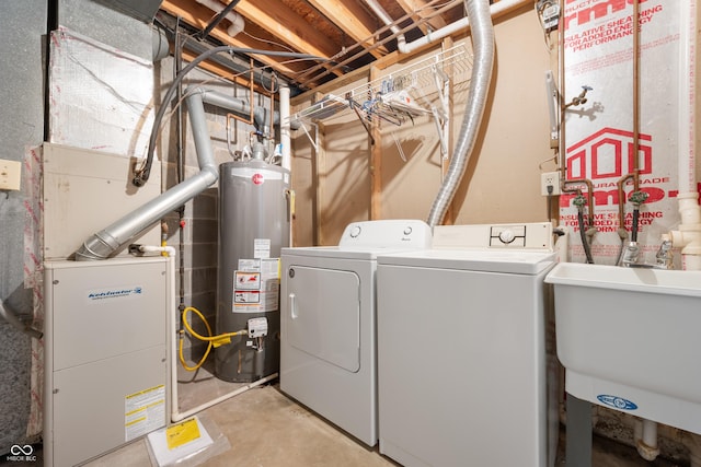 laundry room with gas water heater, sink, and independent washer and dryer