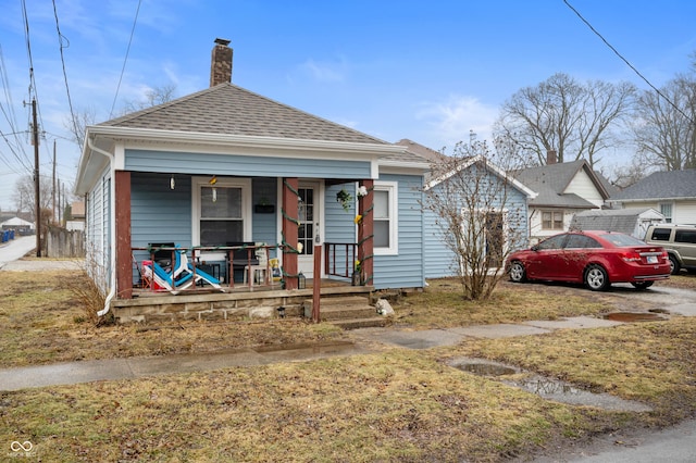 bungalow-style house with a front yard and a porch