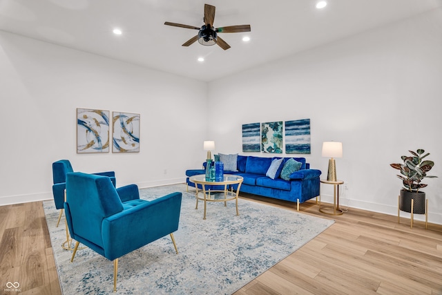 living room with ceiling fan and light wood-type flooring