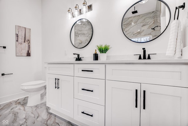 bathroom featuring vanity, toilet, and a shower