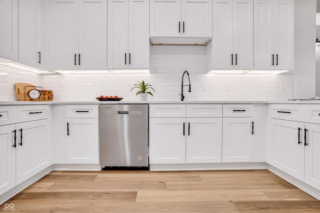 kitchen featuring white cabinetry, dishwasher, and backsplash