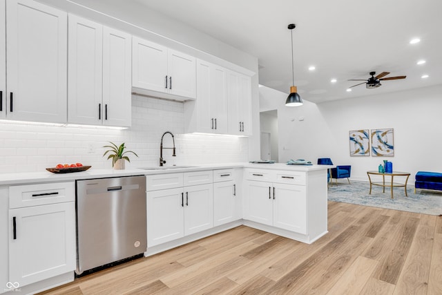 kitchen featuring sink, decorative light fixtures, white cabinets, and dishwasher