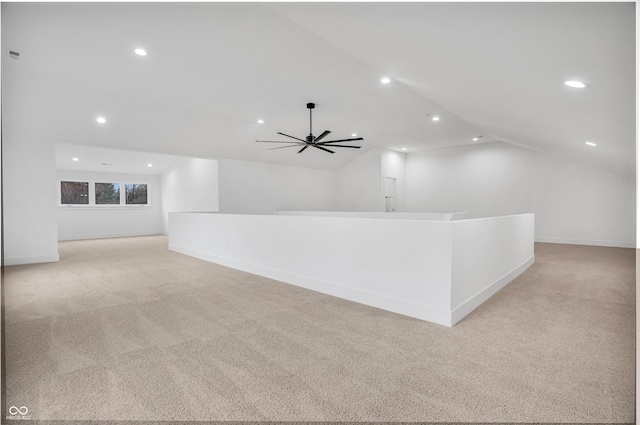 unfurnished living room with lofted ceiling, light colored carpet, and ceiling fan