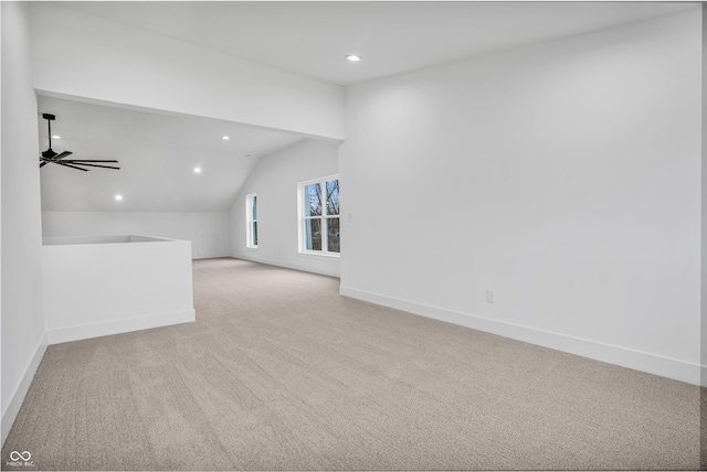 interior space featuring lofted ceiling, light carpet, and ceiling fan