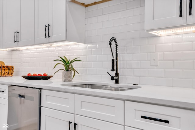 kitchen featuring white cabinetry, sink, tasteful backsplash, and dishwasher