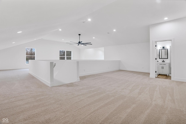 bonus room with light carpet, vaulted ceiling, and ceiling fan