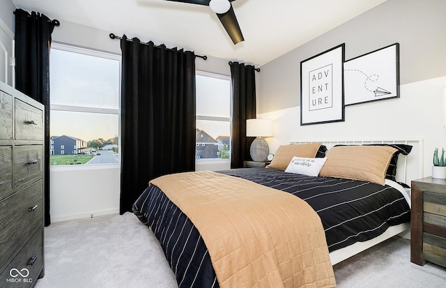 bedroom featuring light colored carpet and ceiling fan