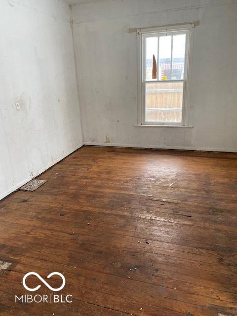 unfurnished room featuring dark wood-type flooring