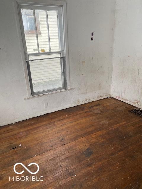 spare room with dark hardwood / wood-style flooring