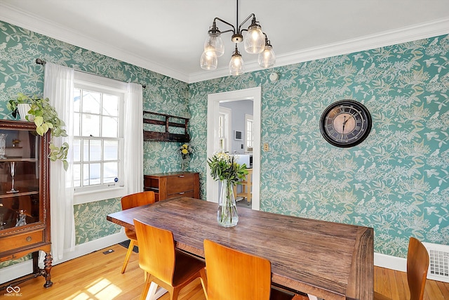 dining room with wood finished floors and wallpapered walls