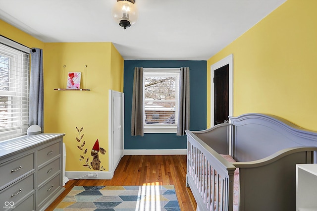 bedroom featuring baseboards and wood finished floors