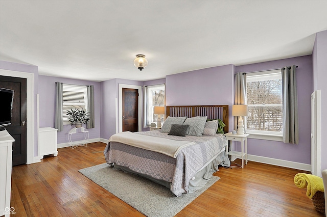 bedroom with light wood-style flooring and baseboards