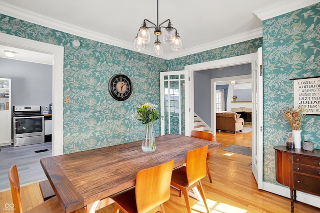 dining space featuring wood finished floors and wallpapered walls