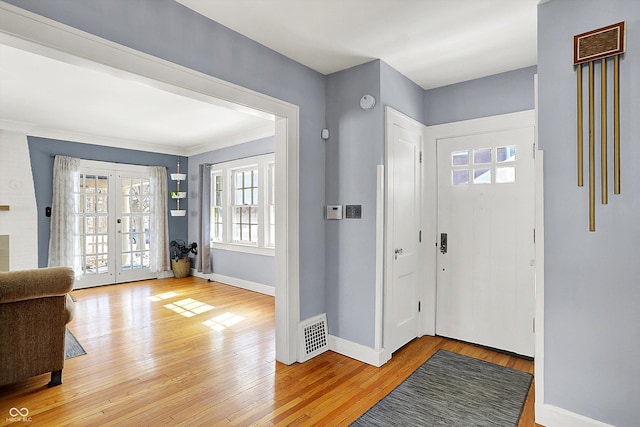 entrance foyer with french doors, visible vents, light wood-style flooring, and baseboards