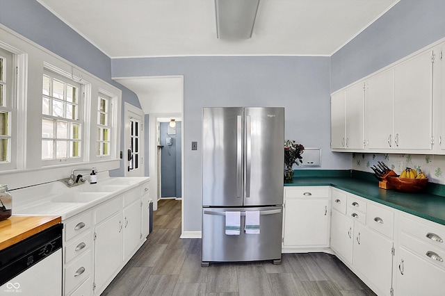 kitchen featuring freestanding refrigerator, white cabinets, dishwasher, and wood tiled floor