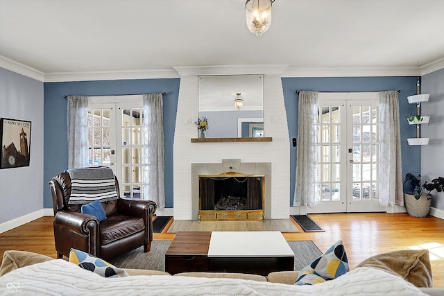 living area featuring a wealth of natural light, french doors, crown molding, and wood finished floors