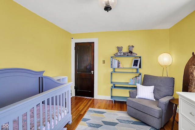 bedroom featuring baseboards and wood finished floors