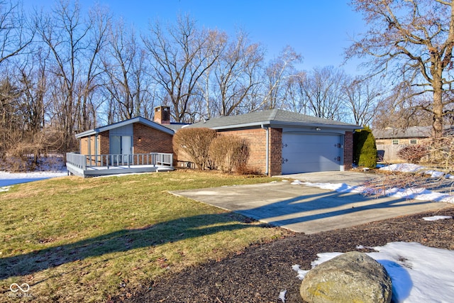 ranch-style house featuring a garage, a wooden deck, and a front lawn