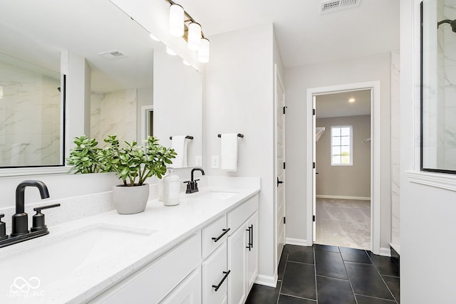 bathroom featuring double vanity, visible vents, and a sink