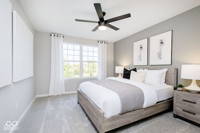 carpeted bedroom featuring a ceiling fan and baseboards