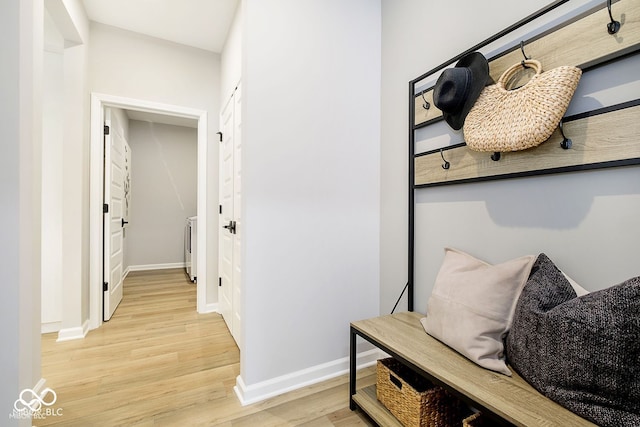 mudroom with baseboards and light wood-style floors