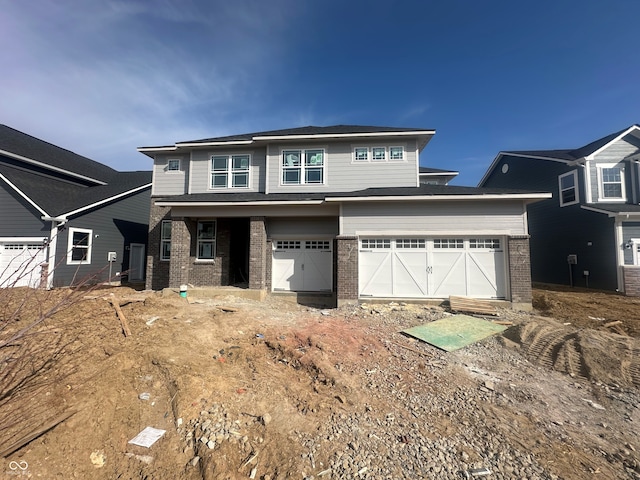 view of front of property with brick siding and an attached garage