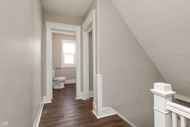 hall featuring dark hardwood / wood-style flooring and a textured ceiling