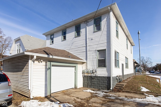 rear view of house with a garage