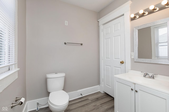 bathroom with vanity, hardwood / wood-style floors, and toilet