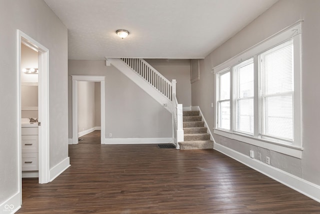 interior space featuring a healthy amount of sunlight, sink, and dark hardwood / wood-style flooring