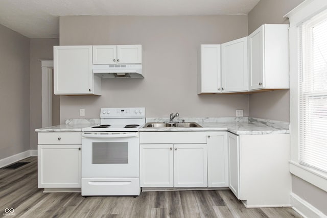 kitchen with white cabinets, light stone countertops, sink, and electric range