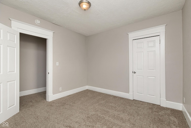 unfurnished bedroom with carpet flooring and a textured ceiling