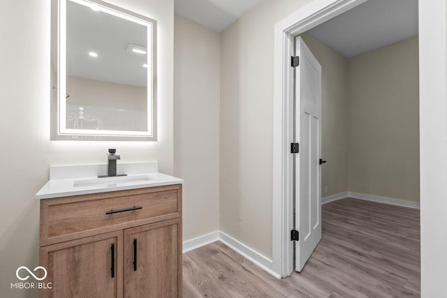 bathroom with vanity and hardwood / wood-style floors