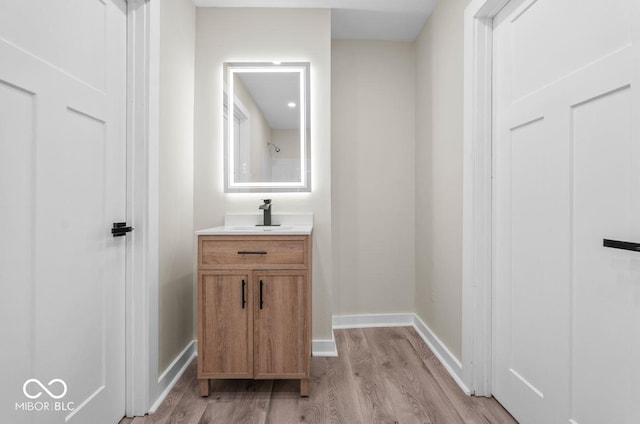 bathroom with hardwood / wood-style flooring and vanity