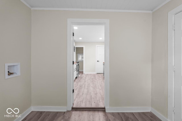 washroom featuring hardwood / wood-style floors, crown molding, and washer hookup