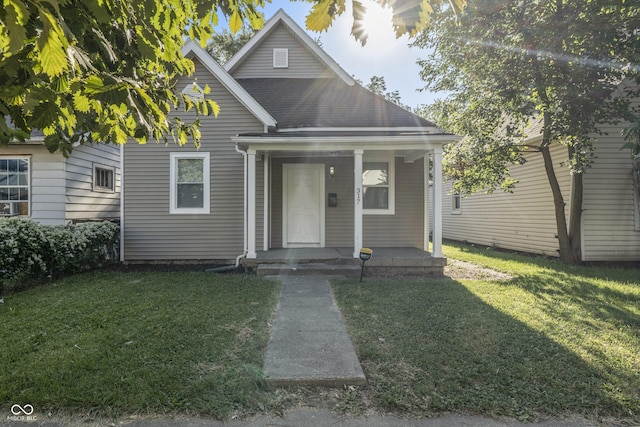 bungalow-style house featuring a porch and a front lawn