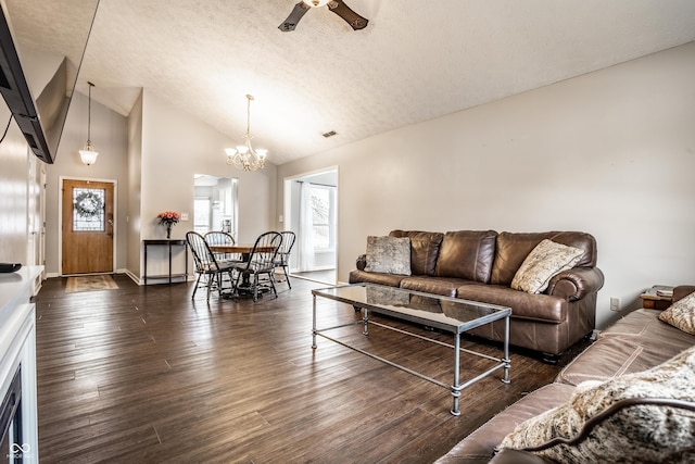 living room featuring high vaulted ceiling, ceiling fan with notable chandelier, a textured ceiling, and dark hardwood / wood-style flooring