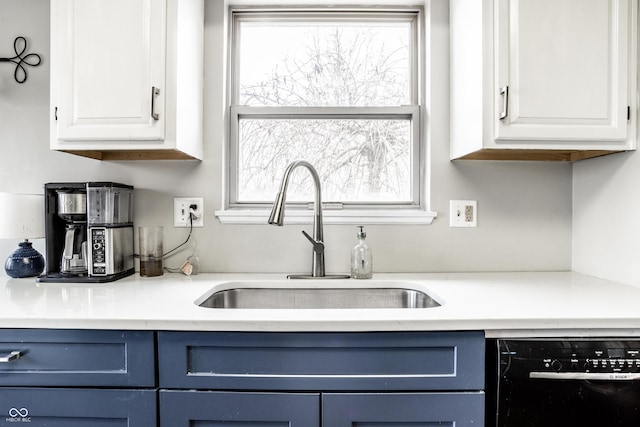 kitchen featuring white cabinetry, black dishwasher, sink, and blue cabinetry