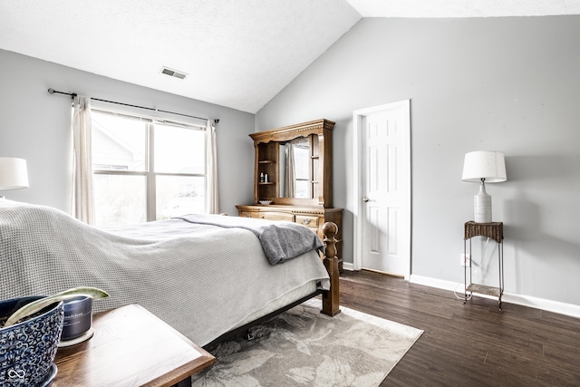 bedroom featuring lofted ceiling and dark hardwood / wood-style flooring