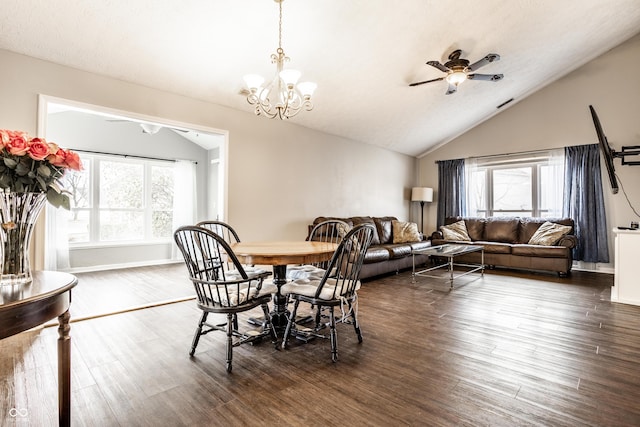 dining room with lofted ceiling, dark hardwood / wood-style floors, a wealth of natural light, and a chandelier