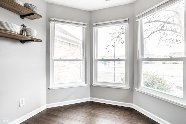 empty room with dark hardwood / wood-style flooring