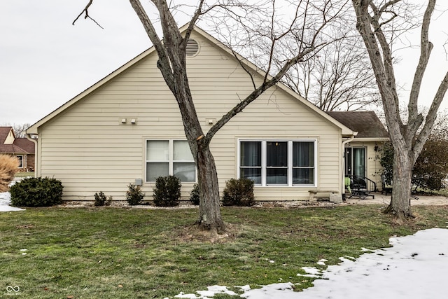 snow covered house with a lawn