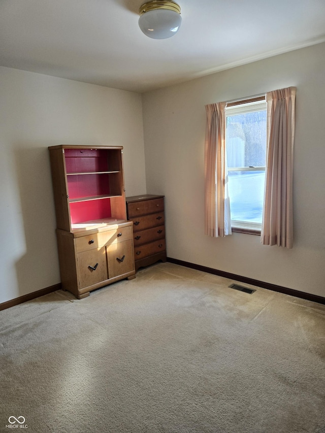 unfurnished bedroom featuring light carpet